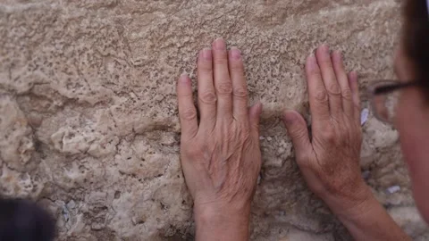 Woman's hands on Western Wall with notes of paper containing written prayers Stock Footage 243170245