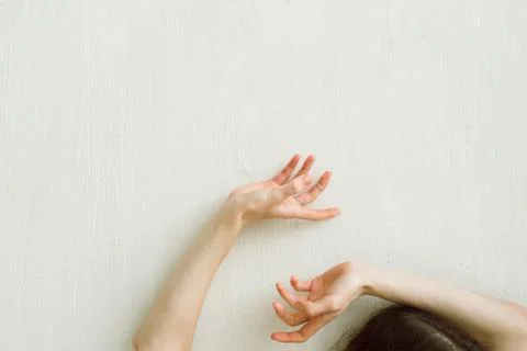 Woman's hands on the white wall, selective focus Stock Photos