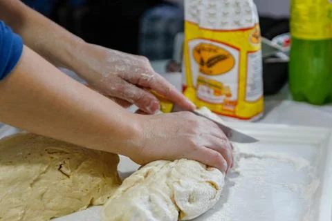 Woman's hands work with dough in the kitchen Stock Photos
