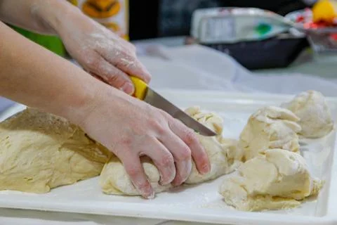Woman's hands work with dough in the kitchen Stock Photos