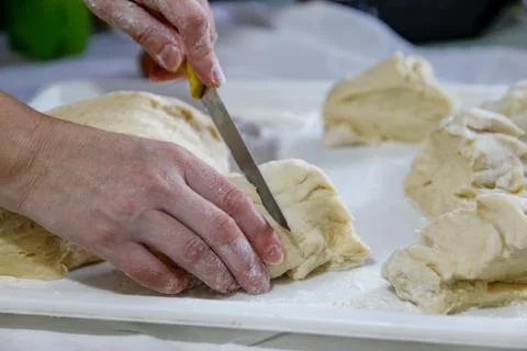 Woman's hands work with dough in the kitchen Stock Photos