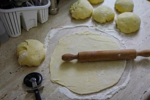 Woman's hands work with dough in the kitchen Stock Photos