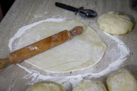 Woman's hands work with dough in the kitchen Stock Photos