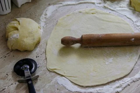 Woman's hands work with dough in the kitchen Stock Photos