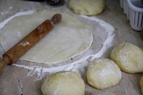 Woman's hands work with dough in the kitchen Stock Photos