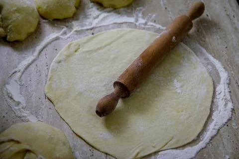 Woman's hands work with dough in the kitchen Stock Photos