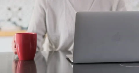 Woman's hands work at laptop and drink coffee from red cup. Close-up, front view Vidéo 237014779