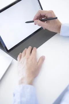 Woman's hands working with her tablet in her office Stock Photos