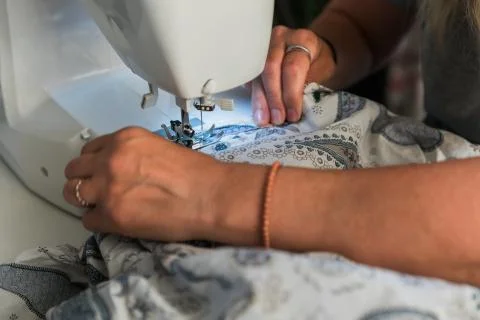 Woman's hands working with a sewing machine Stock Photos