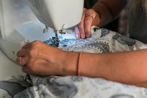 Woman's hands working with a sewing machine Stock Photos