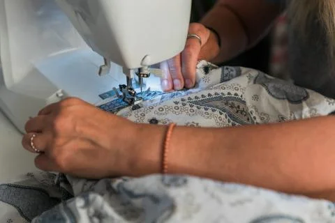 Woman's hands working with a sewing machine Stock Photos