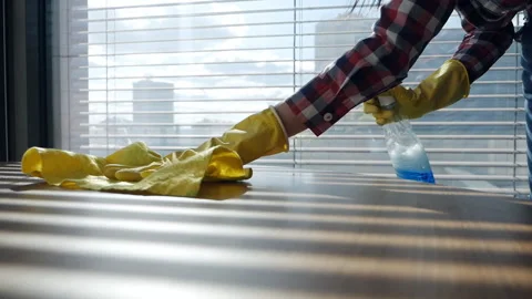 Woman's hands in yellow protective rubber gloves cleaning dust on a wooden table Stock Footage 160292091