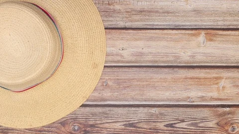 Woman's hat spin in circle on left side of wooden table - Stop motion looping Stock Footage 123123144