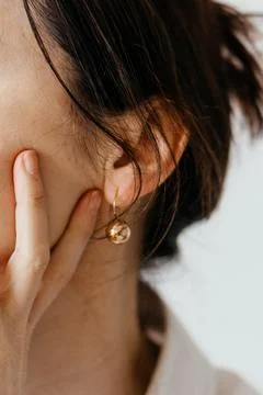 Woman's head erring on an ear Stock Photos