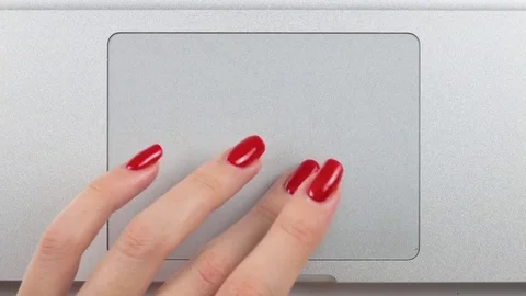 Woman's left hand with red manicure using and clicking a trackpad. Top view Vídeos de archivo 84757061