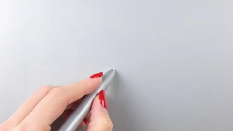 Woman's left hand with red manicure using pen tablet. Top view. Close-up Stockbeeldmateriaal 84757289