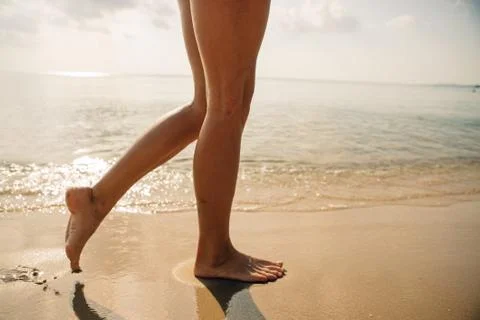 Woman's leg on beach Stock Photos
