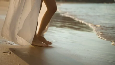 Woman's legs go into the ocean. Close-up of the legs Stock Footage 201168320