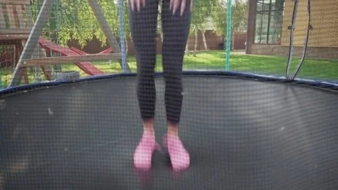 Woman's legs jumping on trampoline Video stock 80396395