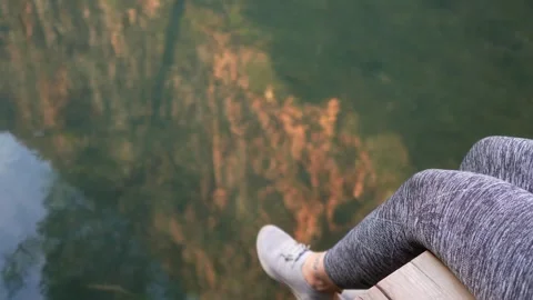 Woman's legs moving over river water Stock Footage 262962879