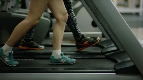 Woman's legs walking on treadmill Stock Footage 64570159