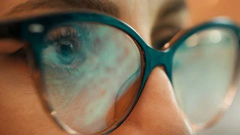 Woman's macro glasses with a PC reflection Stock Photos