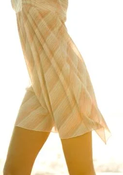 Woman's mid-section, wearing light dress Stock Photos