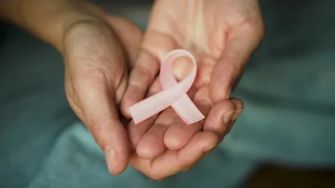 Womans Open Hands Presenting Pink Breast Cancer Awareness Ribbon Stock-Footage 318057324