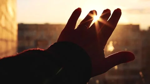 A woman's palm plays with a sunbeam at sunset Video stock 333206479