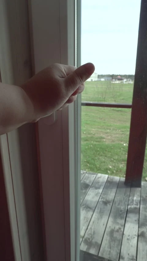 A woman's plump hand opens the window. Stock Footage 334947965