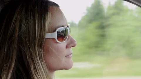Woman's profile driving a car Stock Footage 76317856