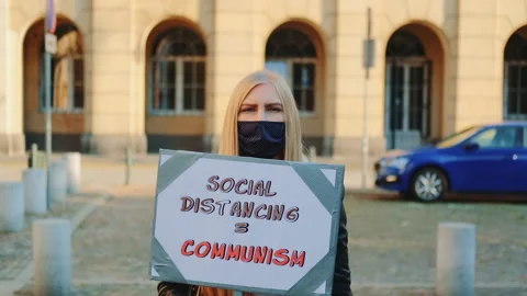 Woman's protest walk with streamer against social distancing that equals Video stock 151967231