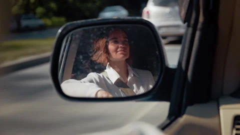 Woman's reflection in a car side mirror during a journey Stock Footage 328560841