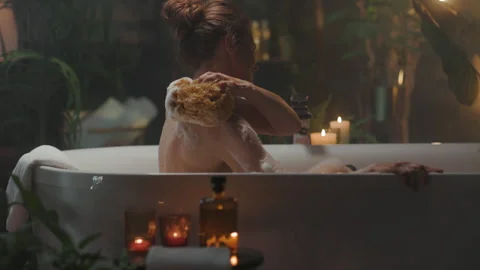 Woman's Tranquil Back Scrub in a Spa Bath Stock Footage 310747383