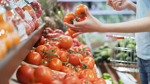 Woman's white hands take few colorful tomatoes in marketplace and hold. Closeup Stock Footage 199491812