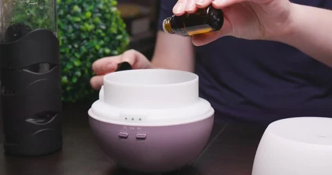 Women Adding Essential Oils and Water to Diffuser Stock-Footage 111989445