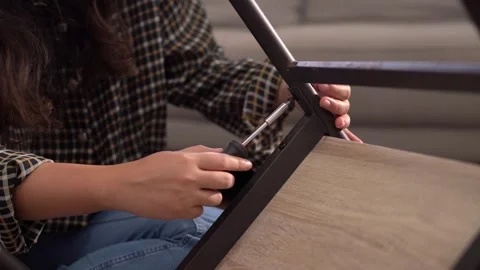 Women adjusting or repair assembling chair Furniture at home diy concept. Video stock 246778286
