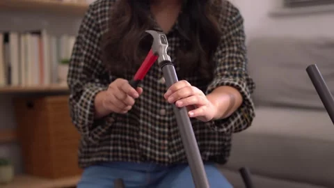 Women adjusting or repair assembling chair Furniture at home diy concept. Video stock 246778296