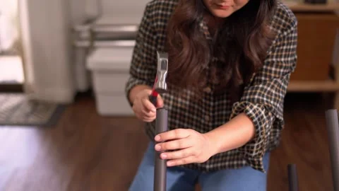 Women adjusting or repair assembling chair Furniture at home diy concept. Video stock 246778298