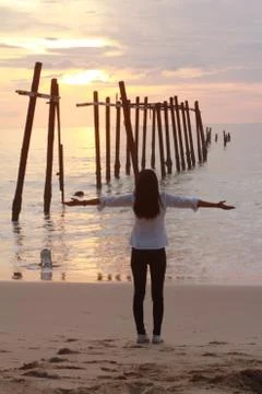 Women alone sunset Beach In Thailand Stock Photos