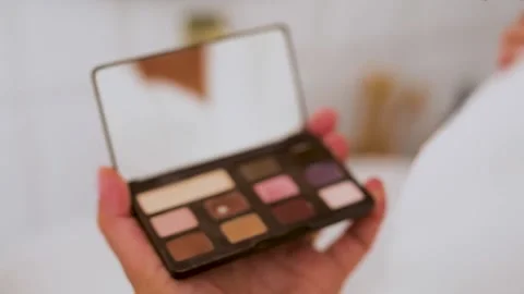 Women applying eye make up on herself Stock Footage 322202080