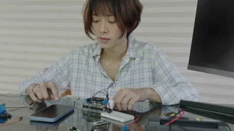 Women are learning and experimenting with the operation of microcontrollers Stock Footage 334046220