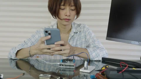 Women are learning and experimenting with the operation of microcontrollers Stock Footage 334046324