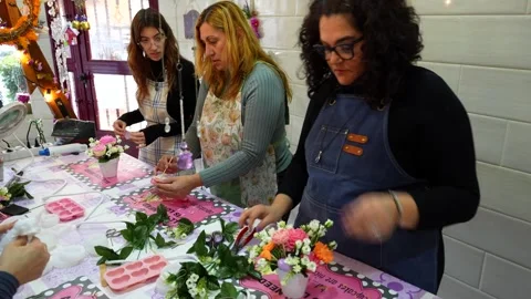 Women attending a creative candle making workshop Stock Footage 334632905