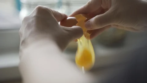 Women break an egg Stock Footage 129690769