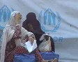 Women in Burqa sit outside UNHCR Camp in Pakistan SD Footage