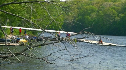 Women carrying their scull back to boathouse Stock Footage 7899853