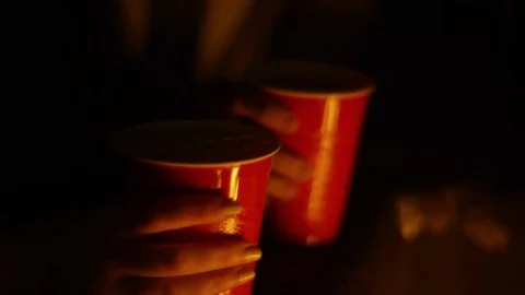 Women Celebrate Together At A Beach Bonfire, They Cheers And Drink From Red Cups Stock Footage