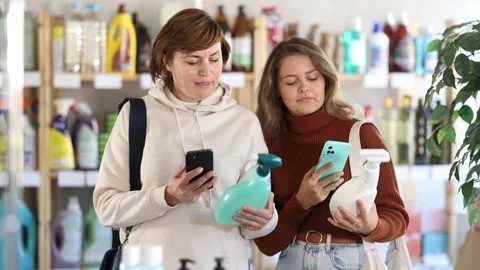 Women clients scans QR code on package and downloads promo code to purchase Stock Footage 310961399