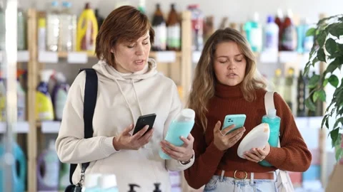 Women clients scans QR code on package and downloads promo code to purchase Stock Footage 311839998